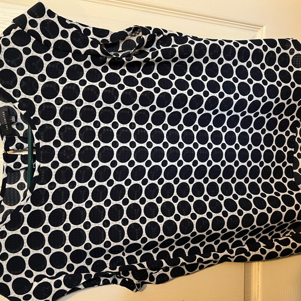 Great piece for the office! Eyelet close detail in back with minimal sleeve.
